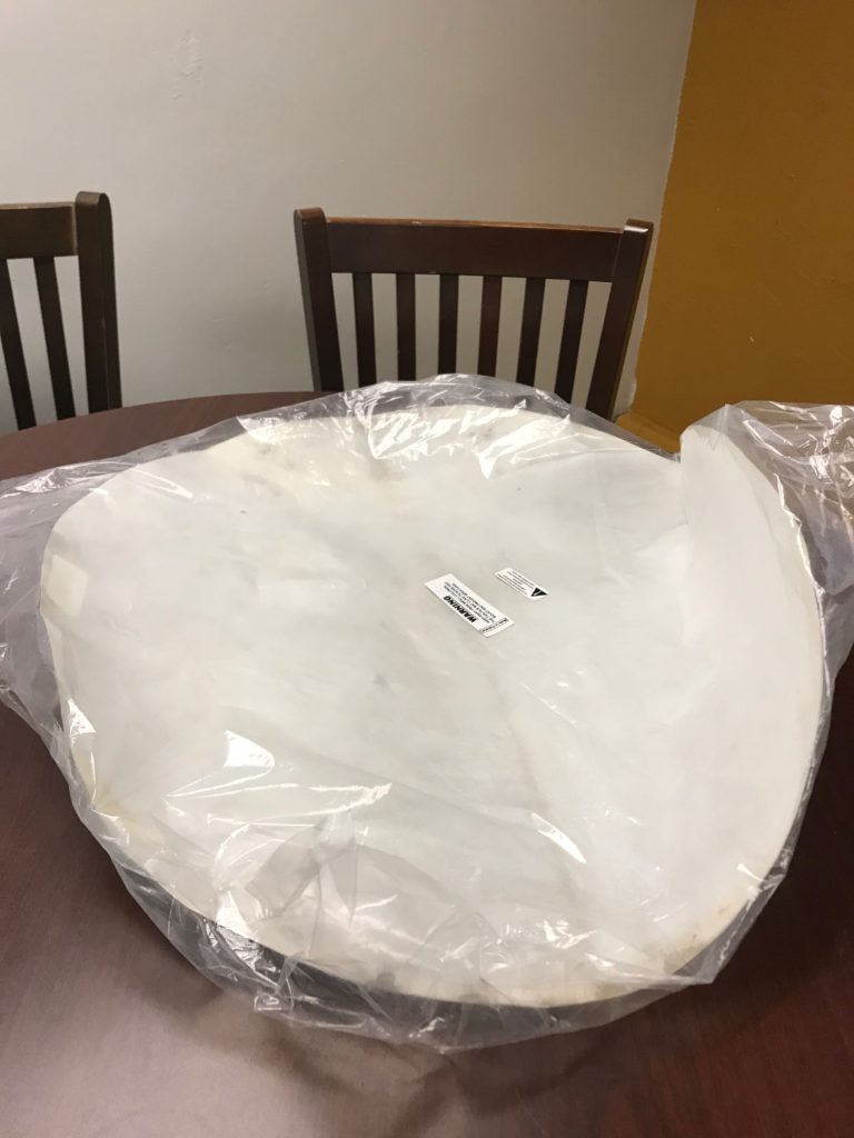 Image of goat skin, a large white 27 inch disk of thin paper like material, in plastic packaging unboiled 