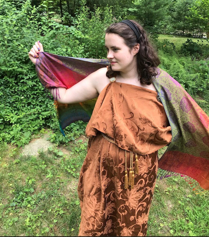 Photo of me wearing an orange tablecloth, fashioned into a peplos (ancient greek dress)