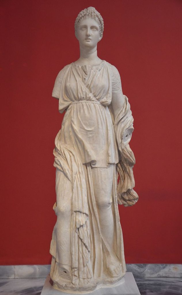 image of a statue of Artemis (young woman with crown) wearing a peplos